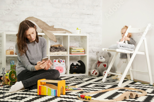 Irresponsible babysitter hanging on the phone and doesn't pay attention to the baby