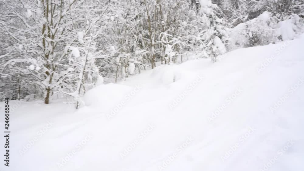 Extreme snowboarder riding fresh powder snow down the steep mountain slope Extreme snowboarder riding fresh powder snow down the steep mountain slope