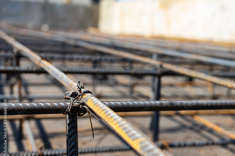Tie rebar beam cage on construction site. Steel reinforcing bar for reinforced concrete. Tie rebar beam cage on construction site. Steel reinforcing bar for reinforced concrete.