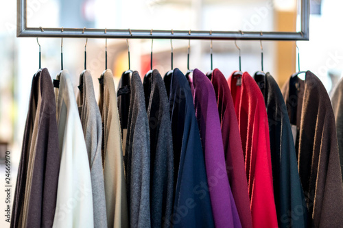 Clothing jersey cashmere items on a rack in fashion store. Capsule wardrobe, winter spring sale
