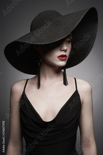 portrait of young lady with black hat and evening dress