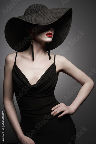 portrait of young lady with black hat and evening dress