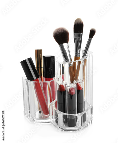 Lipstick holder with different makeup products on white background