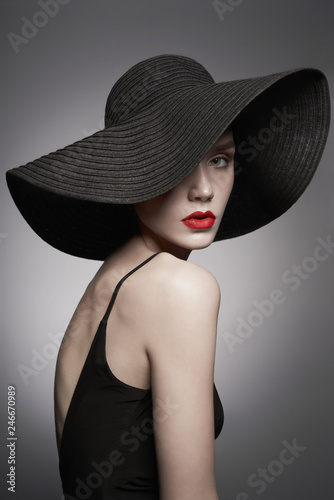 portrait of young lady with black hat and evening dress