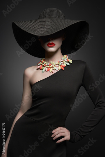 portrait of young lady with black hat and evening dress