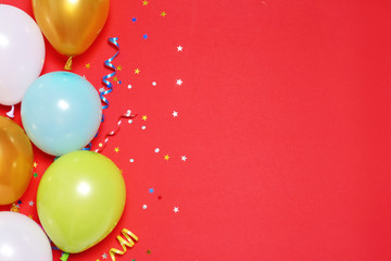 Flat lay composition with balloons and space for text on color background