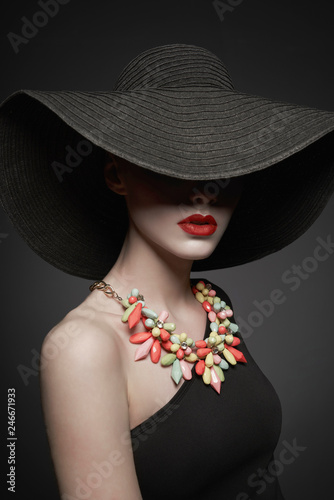 portrait of young lady with black hat and evening dress