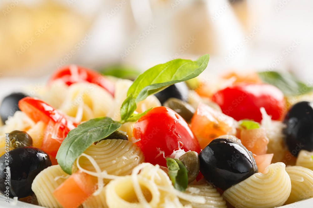 traditional Italian pasta Pipe Rigate with tomatoes, olives.