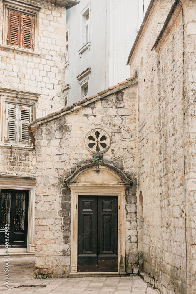 Traditional architecture in the Old Town in Kotor in Montenegro. In the foreground is the door of the building.