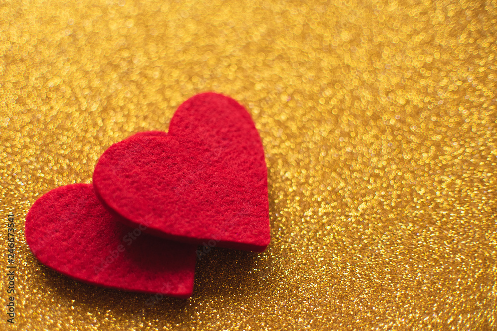Red felt hearts on golden shiny background. Valentine's Day Red felt hearts on golden shiny background. Valentine's Day