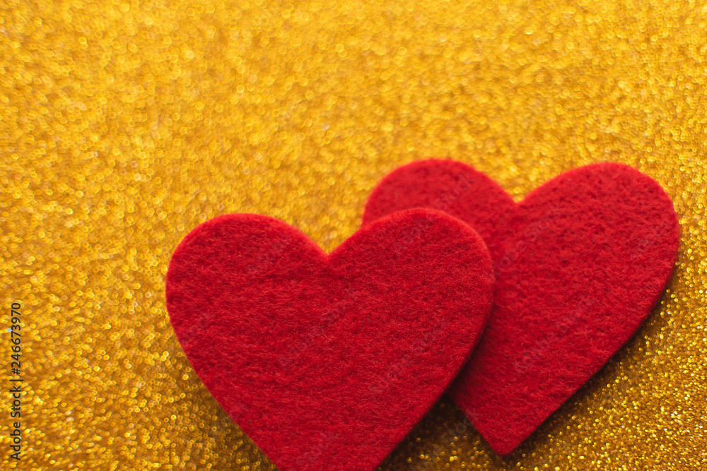 Red felt hearts on golden shiny background. Valentine's Day Red felt hearts on golden shiny background. Valentine's Day