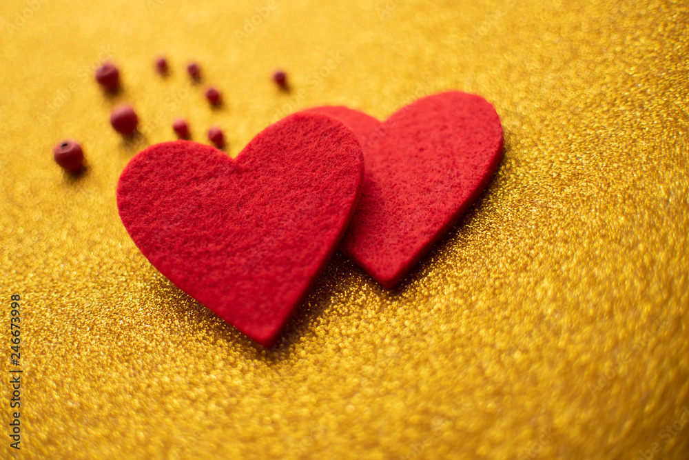 Red felt hearts on golden shiny background. Valentine's Day Red felt hearts on golden shiny background. Valentine's Day