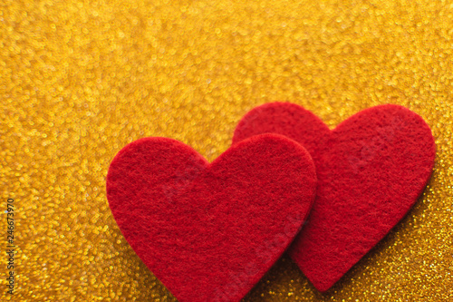 Red felt hearts on golden shiny background. Valentine s Day
