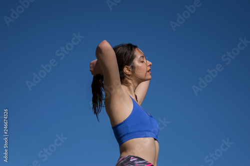 Sport girl tying her hair before training.  © Tremens Productions