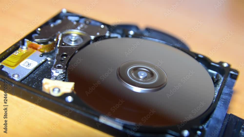 Hard disk, work from the inside, disassembly, rotation of a dusty, dirty disk, reading head, walking. macro Hard disk, work from the inside, disassembly, rotation of a dusty, dirty disk, reading head, walking. macro