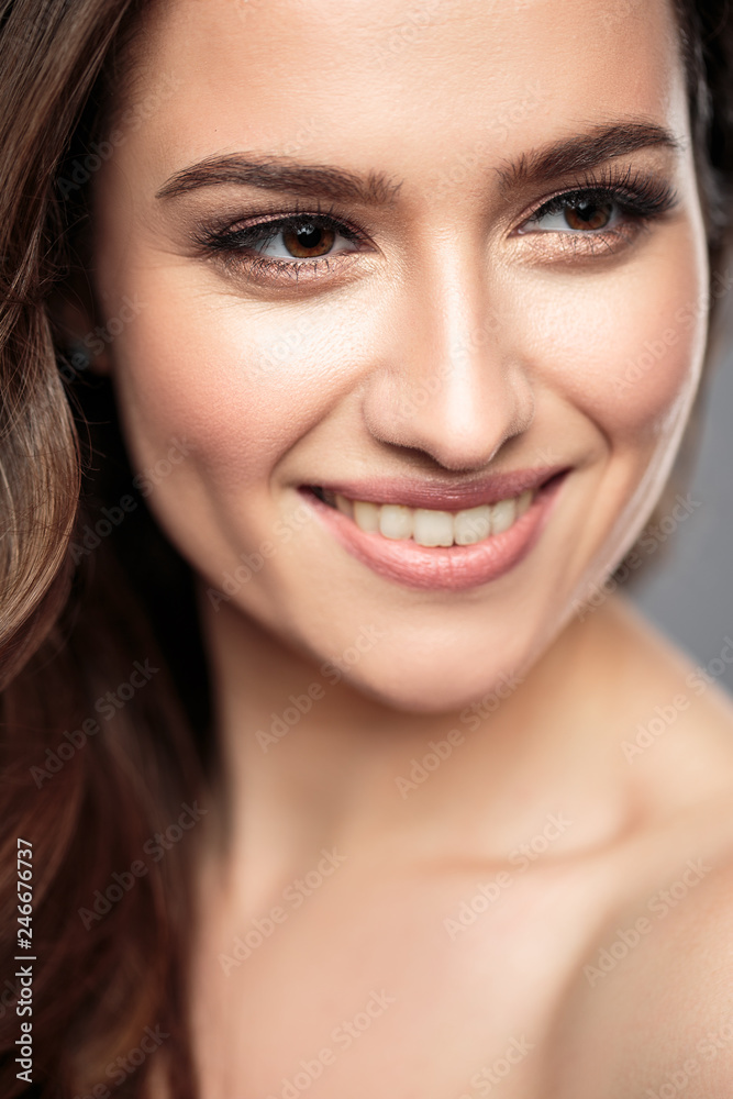 Brunette girl with healthy curly hair and natural make up . Beautiful model woman with wavy hairstyle .Care and beauty Brunette girl with healthy curly hair and natural make up . Beautiful model woman with wavy hairstyle .Care and beauty