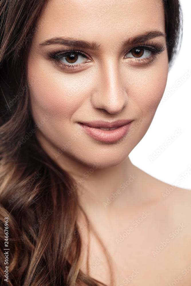 Brunette girl with healthy curly hair and natural make up . Beautiful model woman with wavy hairstyle .Care and beauty Brunette girl with healthy curly hair and natural make up . Beautiful model woman with wavy hairstyle .Care and beauty