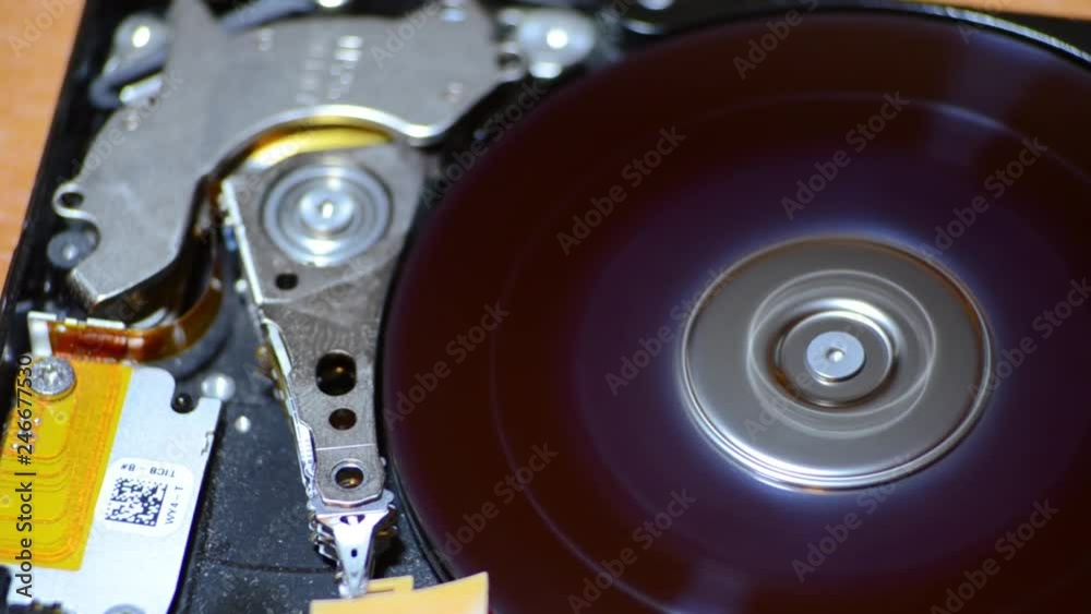 Hard disk, work from the inside, disassembly, rotation of a dusty, dirty disk, reading head, walking. macro Hard disk, work from the inside, disassembly, rotation of a dusty, dirty disk, reading head, walking. macro