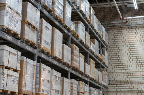 Warehouse with boxes on shelves and racks.