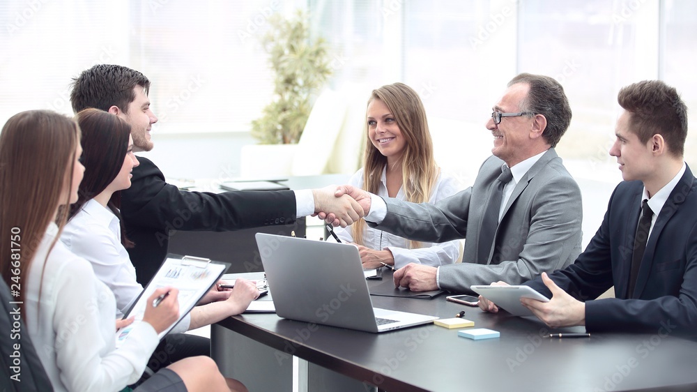 handshake of business partners at the negotiating table handshake of business partners at the negotiating table