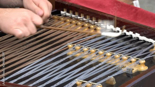 Hammered Dulcimer with player hands with hammers.