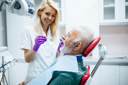 Senior man having dental treatment at dentist's office.