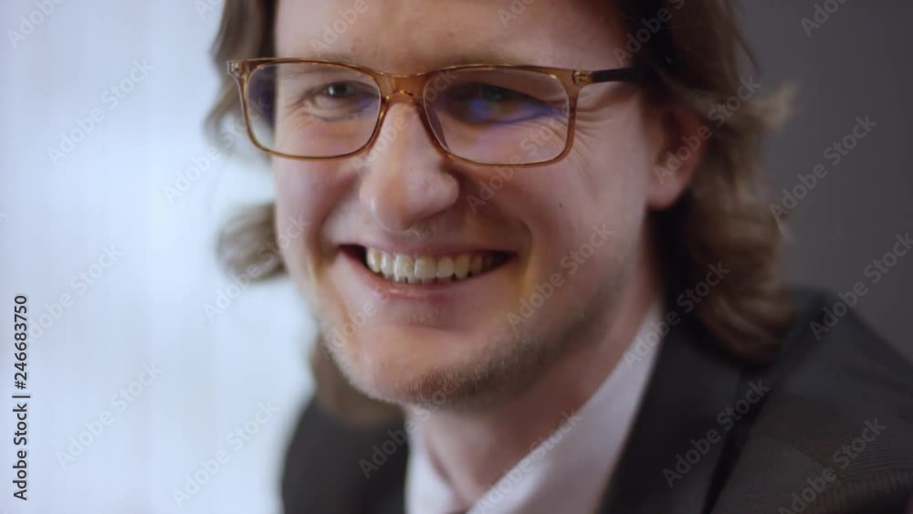close up portrait of young cheerful business man with glasses. laughing happy feeling confident contemporary man is sitting in a cafe. It is a business meeting. Man is sitting in the cafe at the table close up portrait of young cheerful business man with glasses. laughing happy feeling confident contemporary man is sitting in a cafe. It is a business meeting. Man is sitting in the cafe at the table