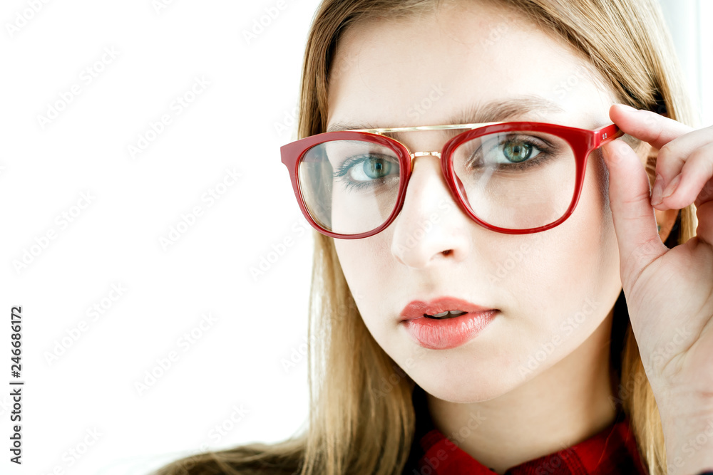 Glasses with a red frame on a young model. Concept photo for advertising glasses for vision.