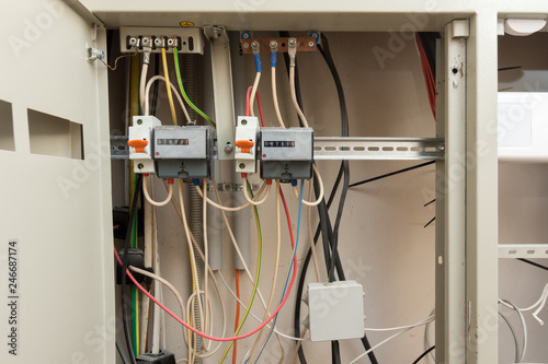 Two electronic electrical meters and a junction box