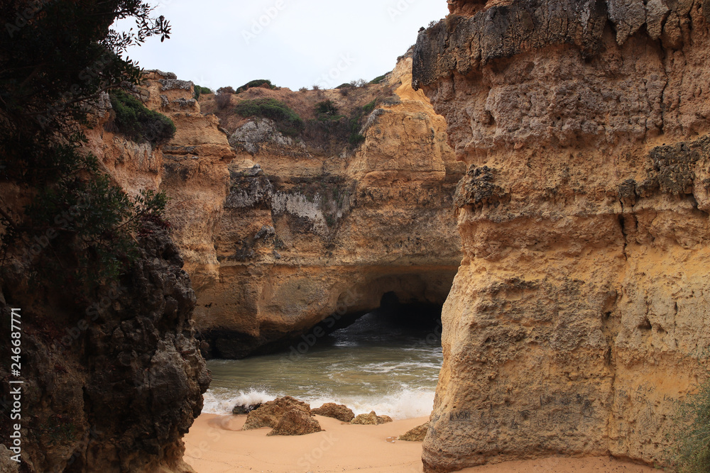 Hidden beach Praia da Ponta Pequena/Small Point Beach in Albufeira, Algarve, Portugal. Only known to locals. Waves coming in through a small opening in the cliff. 