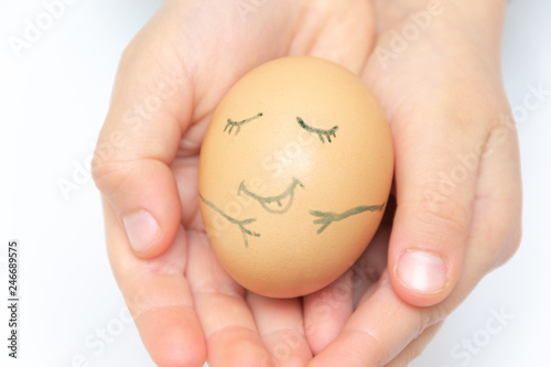 Girl hand with hen egg isolated on white background. Smile and sleep egg
