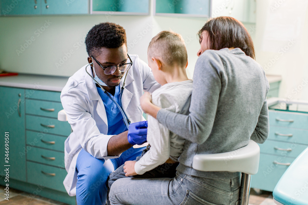 Fototapeta premium Woman with her son visiting children's doctor in hospital