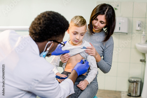 Woman with her son visiting children's doctor in hospital