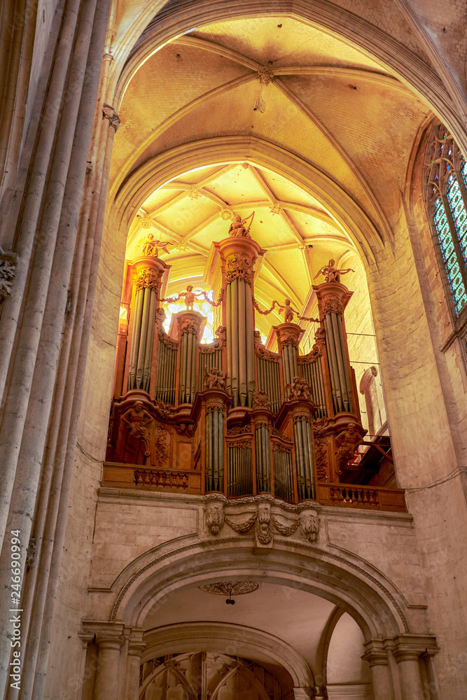 Huge organ instrument undet sunny vault of Troyes cathedral, France