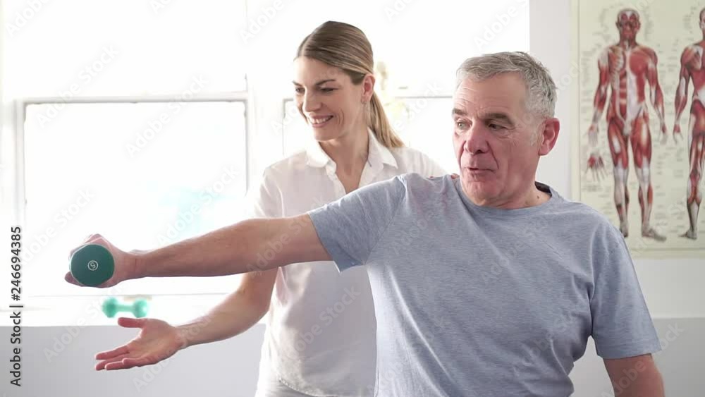 A Modern rehabilitation physiotherapy worker with senior client