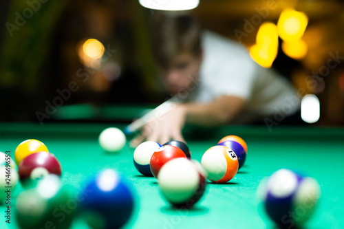Young man playing pool in pub