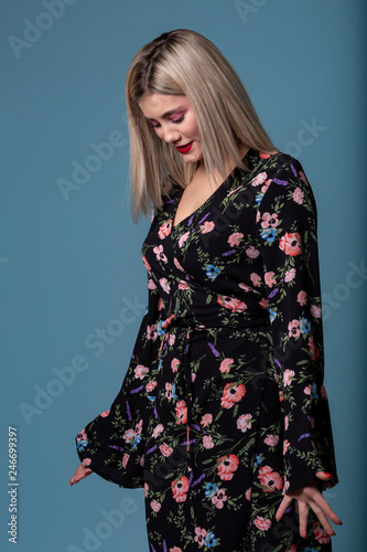 Portrait of fashion young blonde woman in floral dress
