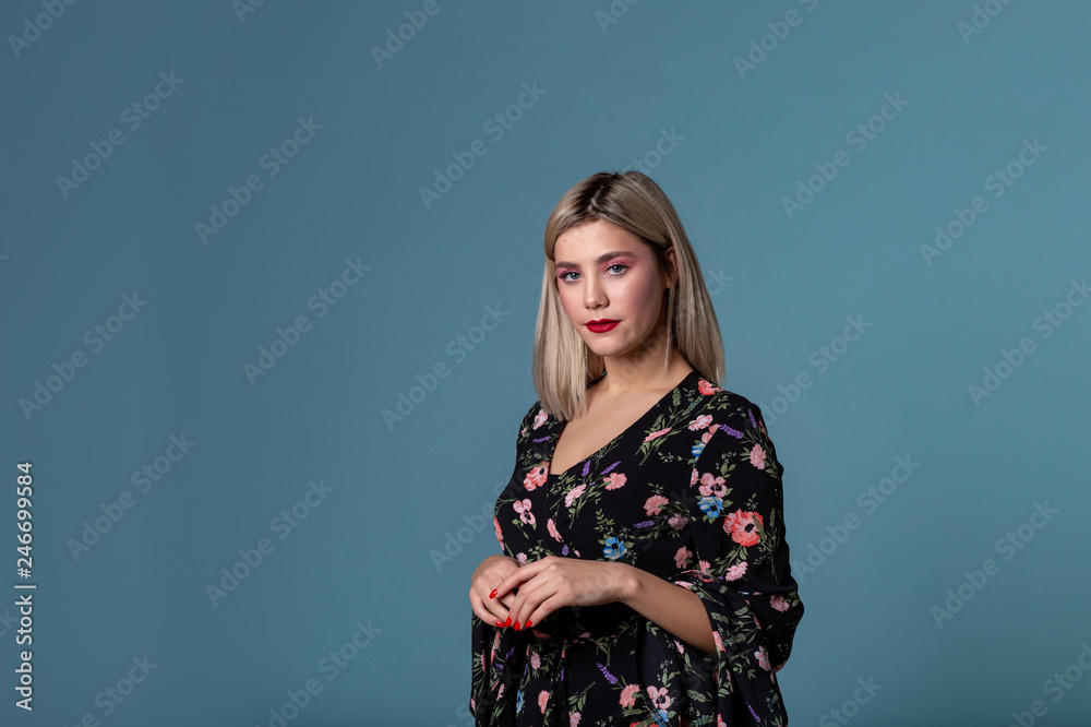 Beautiful young girl with bright lips and blonde hair posing in studio Beautiful young girl with bright lips and blonde hair posing in studio
