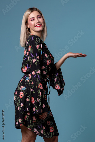 Blonde woman showing copy space for product