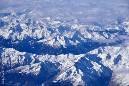Aerial view of the rugged snow covered mountains of the Alps at the junction of Italy, France and Switzerland  © konik60