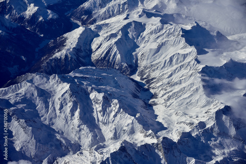 Aerial view of the rugged snow covered mountains of the Alps at the junction of Italy, France and Switzerland 