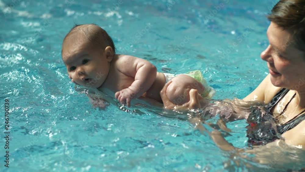 Baby on a hands swimming in water Baby on a hands swimming in water
