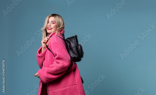 Attractive young female student with a black backpack over her shoulder photo
