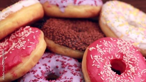 Assorted delicious donuts on rustic wooden background. Unhealthy, but delicious sweets