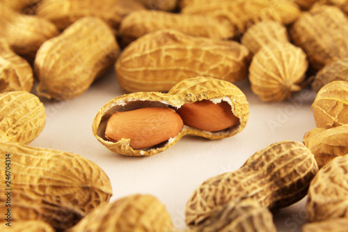 Peeled peanuts on well peanuts in background. Macro image