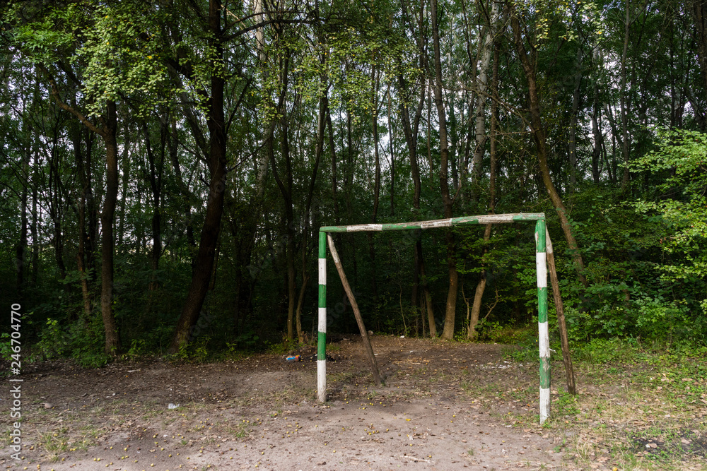 Improvised soccer goalpost on a playground for kids to play sports in a rural forest setting . Improvised soccer goalpost on a playground for kids to play sports in a rural forest setting .