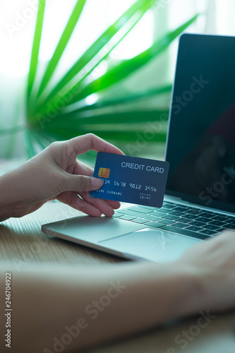 Business and financial concepts. Asian businesses hold credit cards for online purchases via mobile phones, laptops and pay with online banking via credit cards - images.