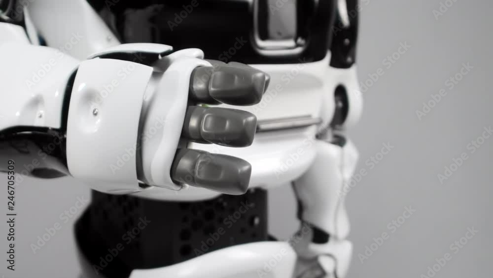 Modern Robotic Technologies. Modern robot in a bright studio. Android raises and bends a hand on a white background. Wants to shake hands with a man Modern Robotic Technologies. Modern robot in a bright studio. Android raises and bends a hand on a white background. Wants to shake hands with a man