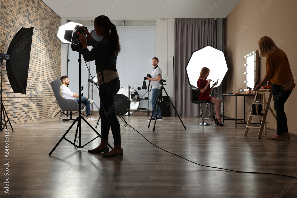 Photo studio with professional equipment and team of workers - obrazy, fototapety, plakaty 