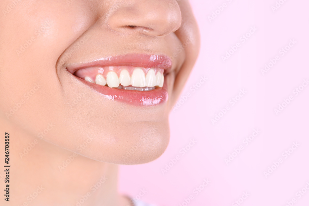 Young woman with healthy teeth and beautiful smile on color background, closeup. Space for text Young woman with healthy teeth and beautiful smile on color background, closeup. Space for text